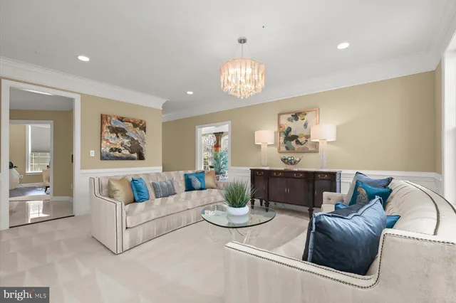 a view of a dining room with furniture and a chandelier