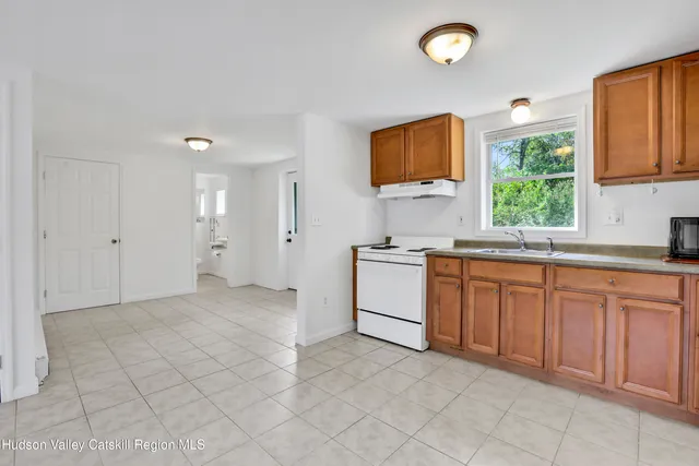 a large kitchen with stainless steel appliances granite countertop a sink and cabinets