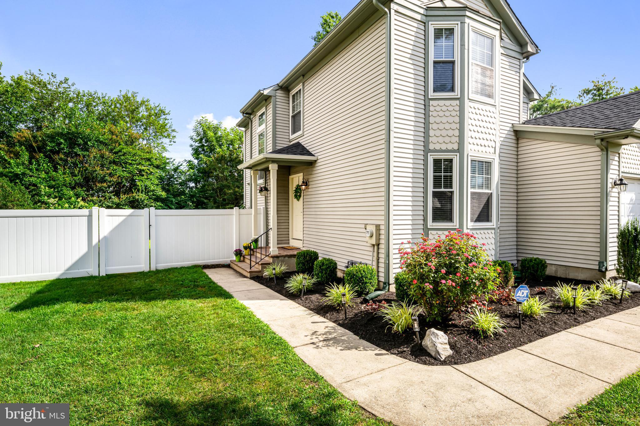 12 Apple Way Marlton, NJ 08053 - Photo 3 of 47 a view of white house with potted plants and a bench