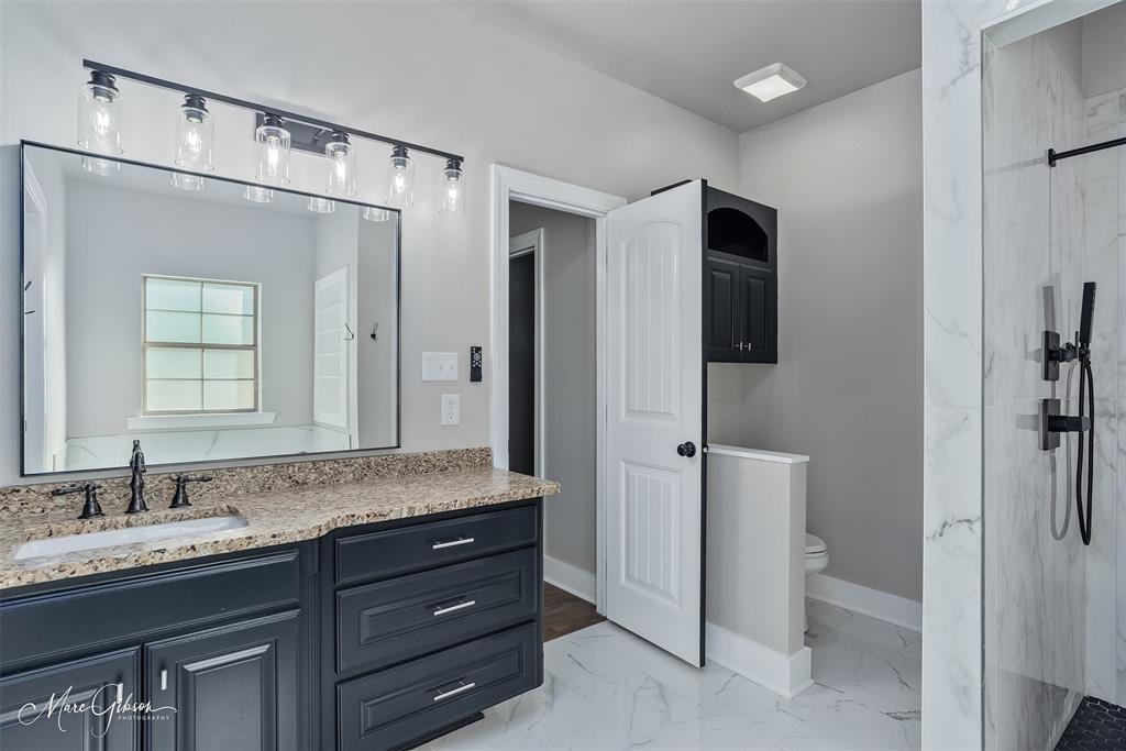 550 Linton Bellevue Road Benton, LA 71006 - Photo 27 of 37 Primary bathroom with a marble finish shower, vanity, and light marble finish floors