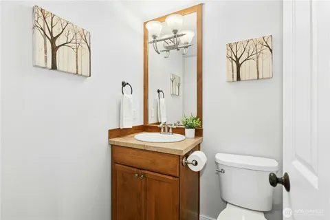 a bathroom with a sink and mirror with toilet