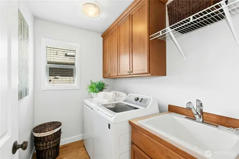 a view of a house with a big yard and large trees