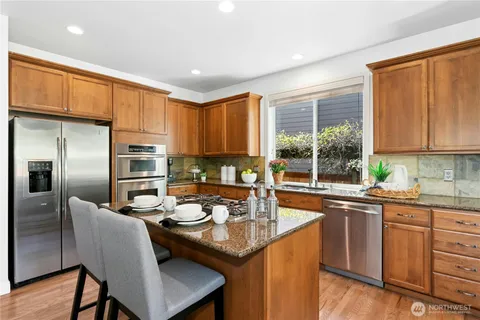 a kitchen with a sink stove and refrigerator