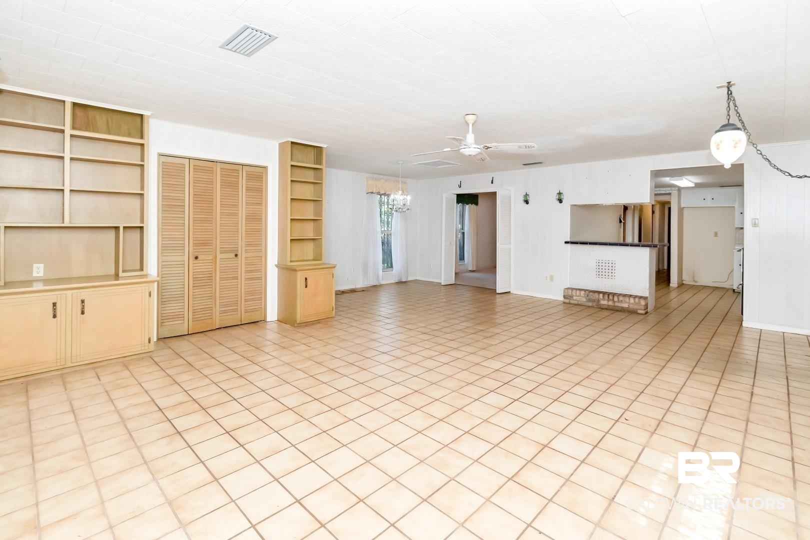 3715 South Conway Drive Mobile, AL 36608 - Photo 6 of 24 Unfurnished living room with ceiling fan with notable chandelier and visible vents