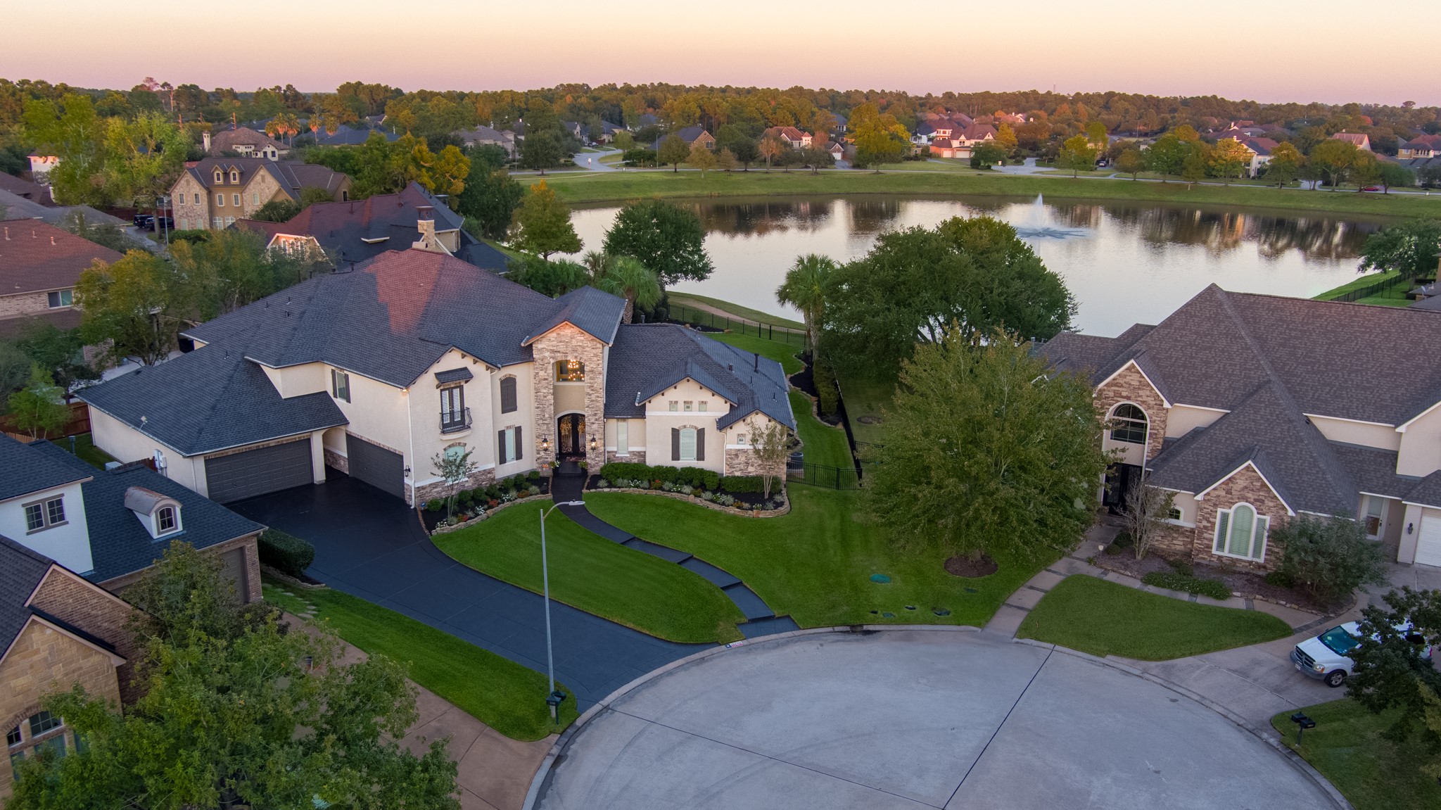 an aerial view of a house with garden space and a lake view
