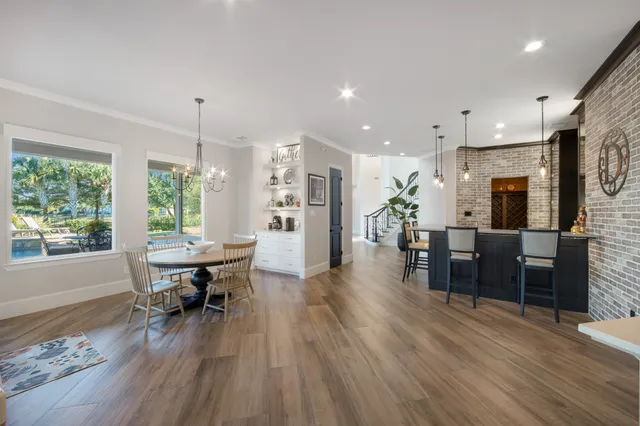 a dining room with furniture and wooden floor