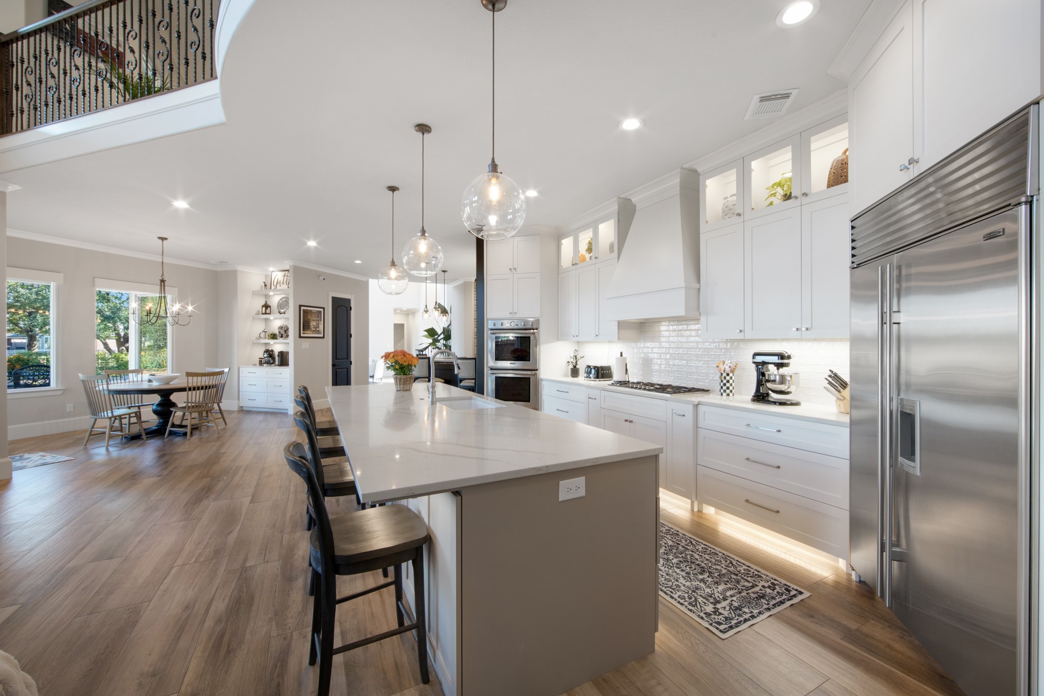 15702 Knauff Ranch Court Cypress, TX 77429 - Photo 16 of 50 a kitchen with stainless steel appliances granite countertop a refrigerator a oven a sink a dining table and chairs with wooden floor