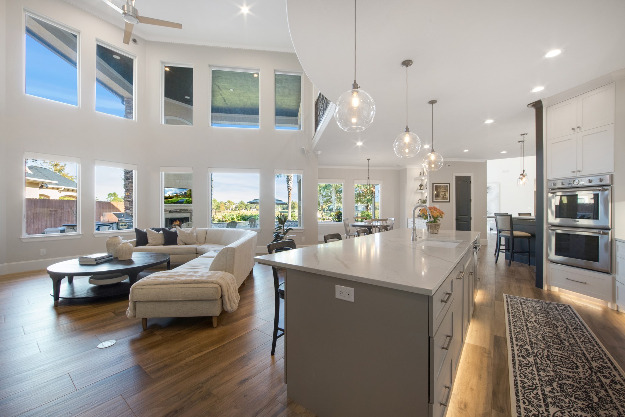 15702 Knauff Ranch Court Cypress, TX 77429 - Photo 19 of 50 a dining hall with couches a flat tv screen and couches with wooden floor