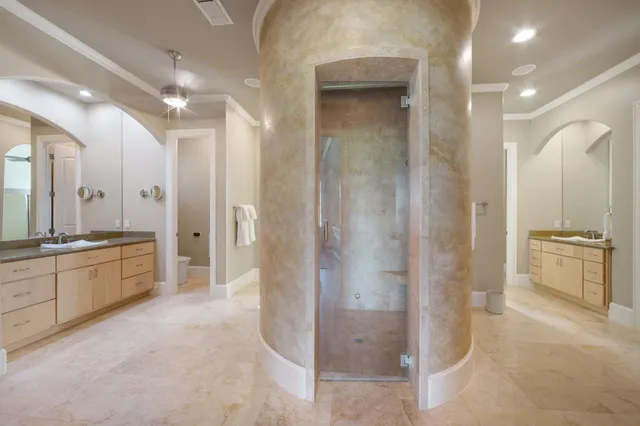 a large bathroom with a glass shower door a sink and a mirror