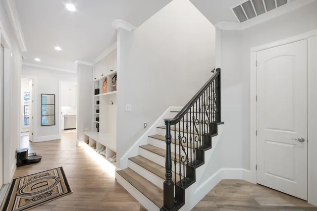 a view of a hallway with wooden floor and entryway