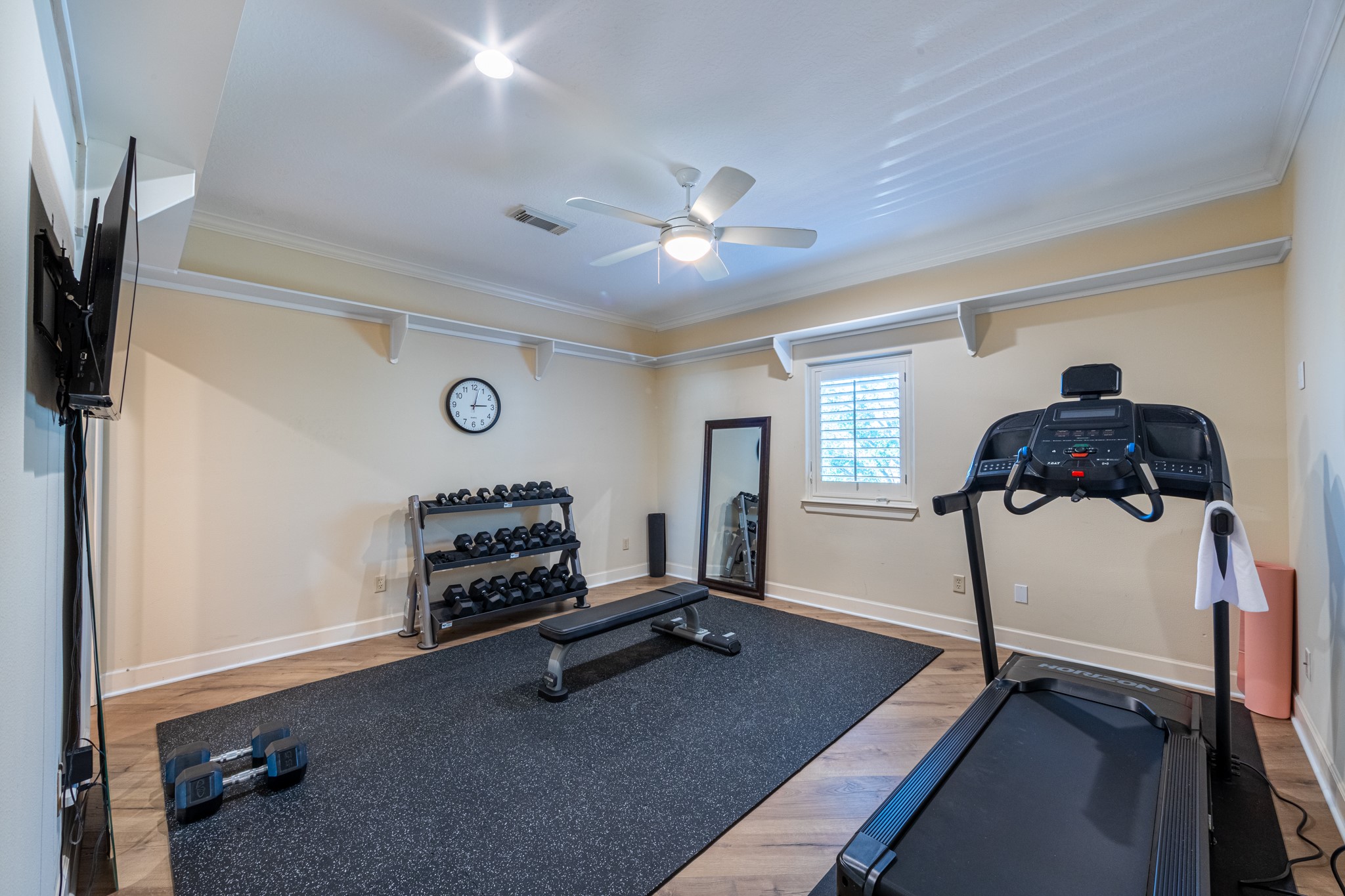 15702 Knauff Ranch Court Cypress, TX 77429 - Photo 38 of 50 a room with gym equipment and a flat screen tv