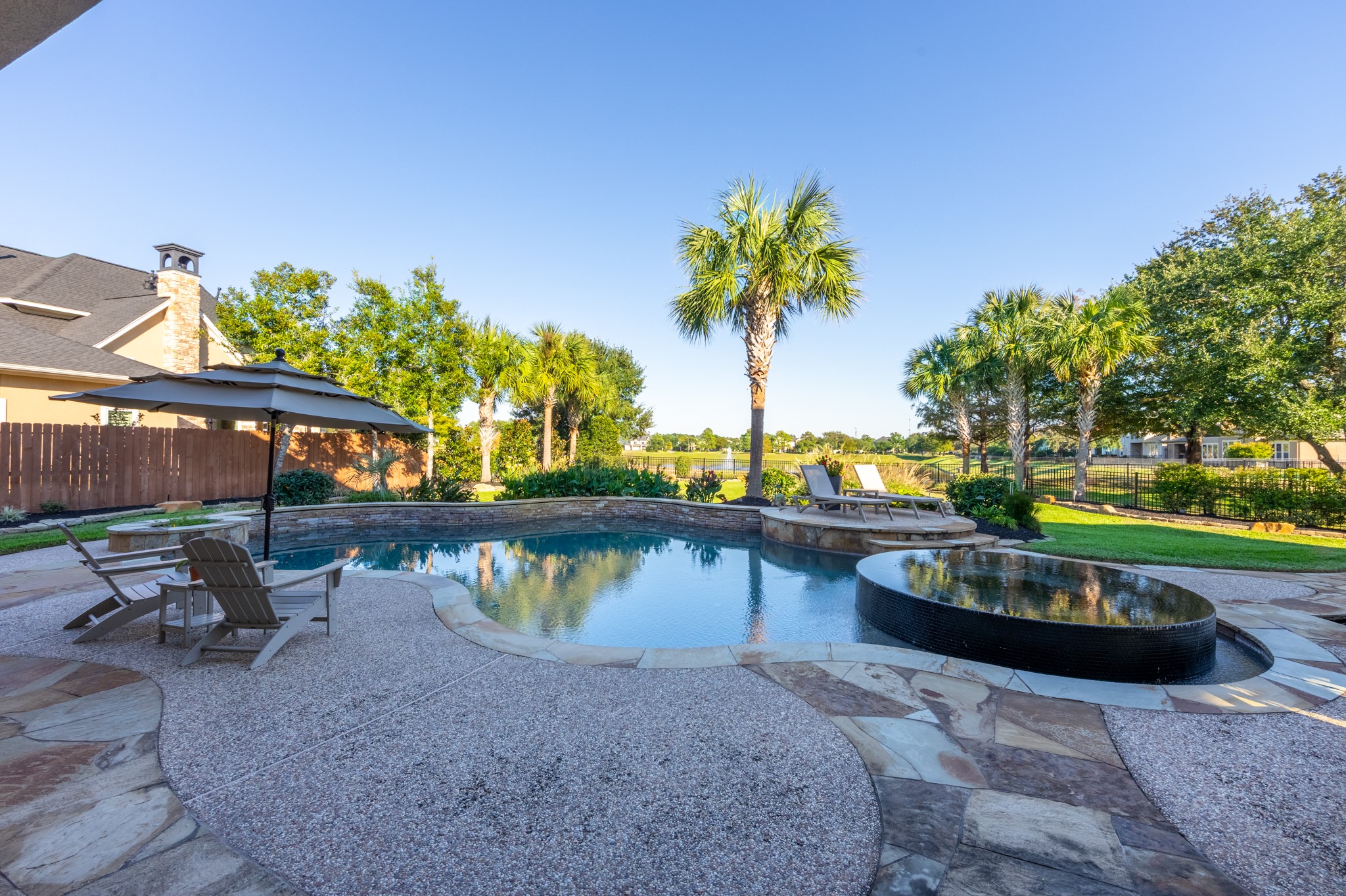15702 Knauff Ranch Court Cypress, TX 77429 - Photo 43 of 50 a view of a swimming pool with a patio and a yard