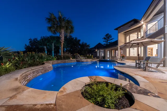 a view of a swimming pool with outdoor seating