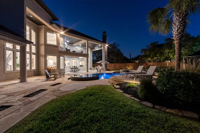 a view of backyard of house with green space