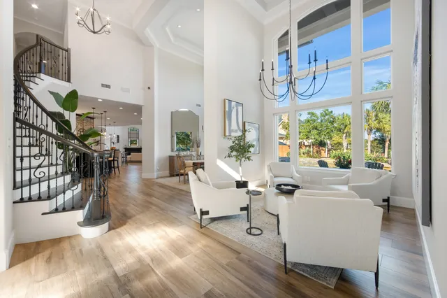 a living room with fireplace furniture and a large window