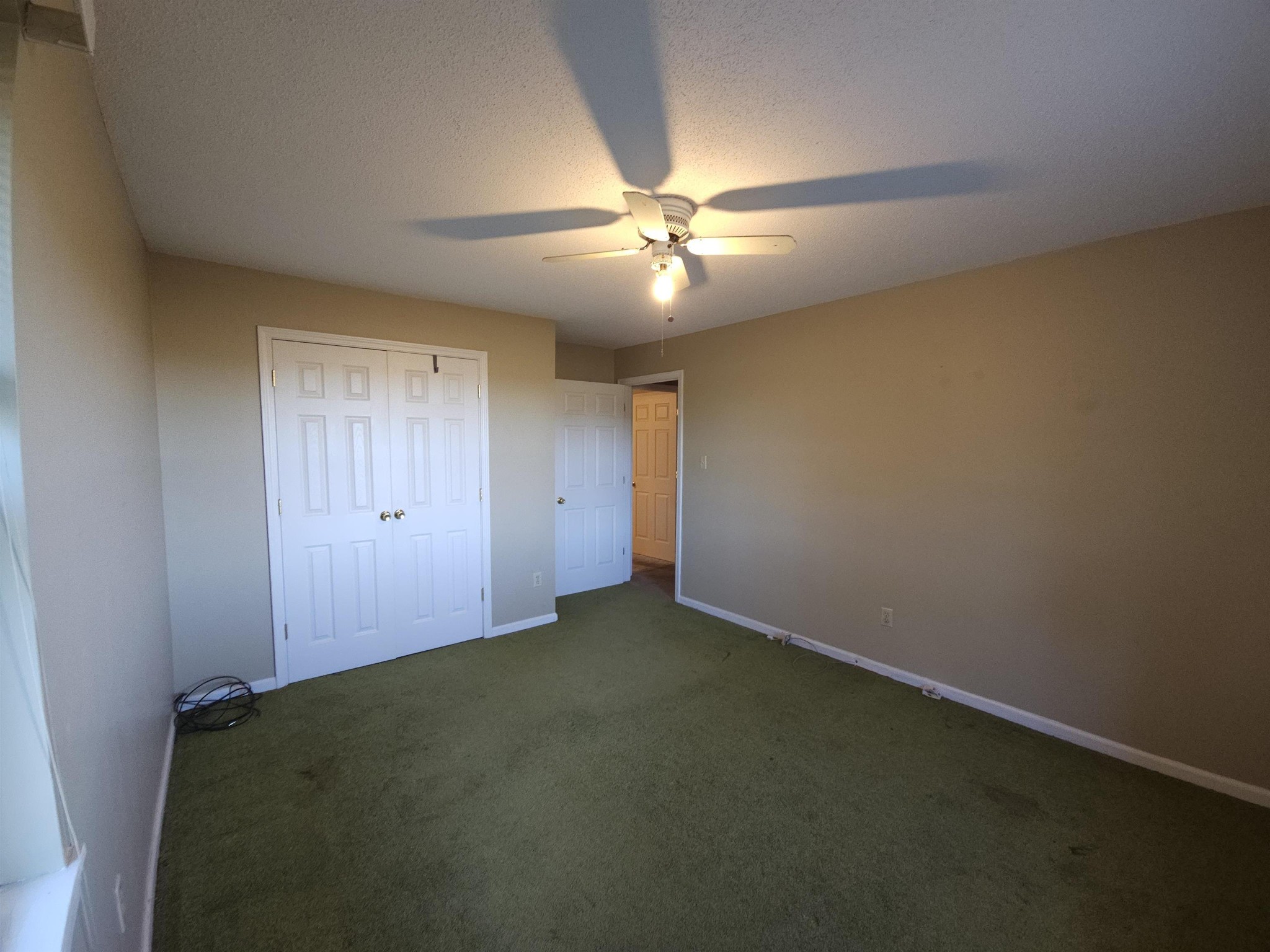 1728 Oil Mill Road Covington, TN 38019 - Photo 18 of 25 an empty room with closet and a ceiling fan