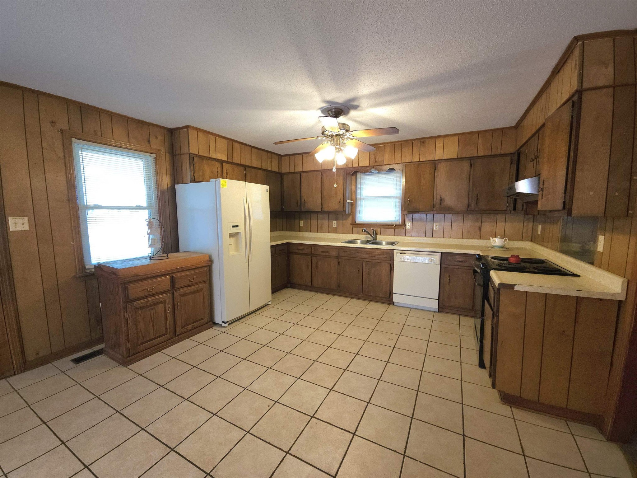 1728 Oil Mill Road Covington, TN 38019 - Photo 2 of 25 a kitchen with a cabinets and white stainless steel appliances