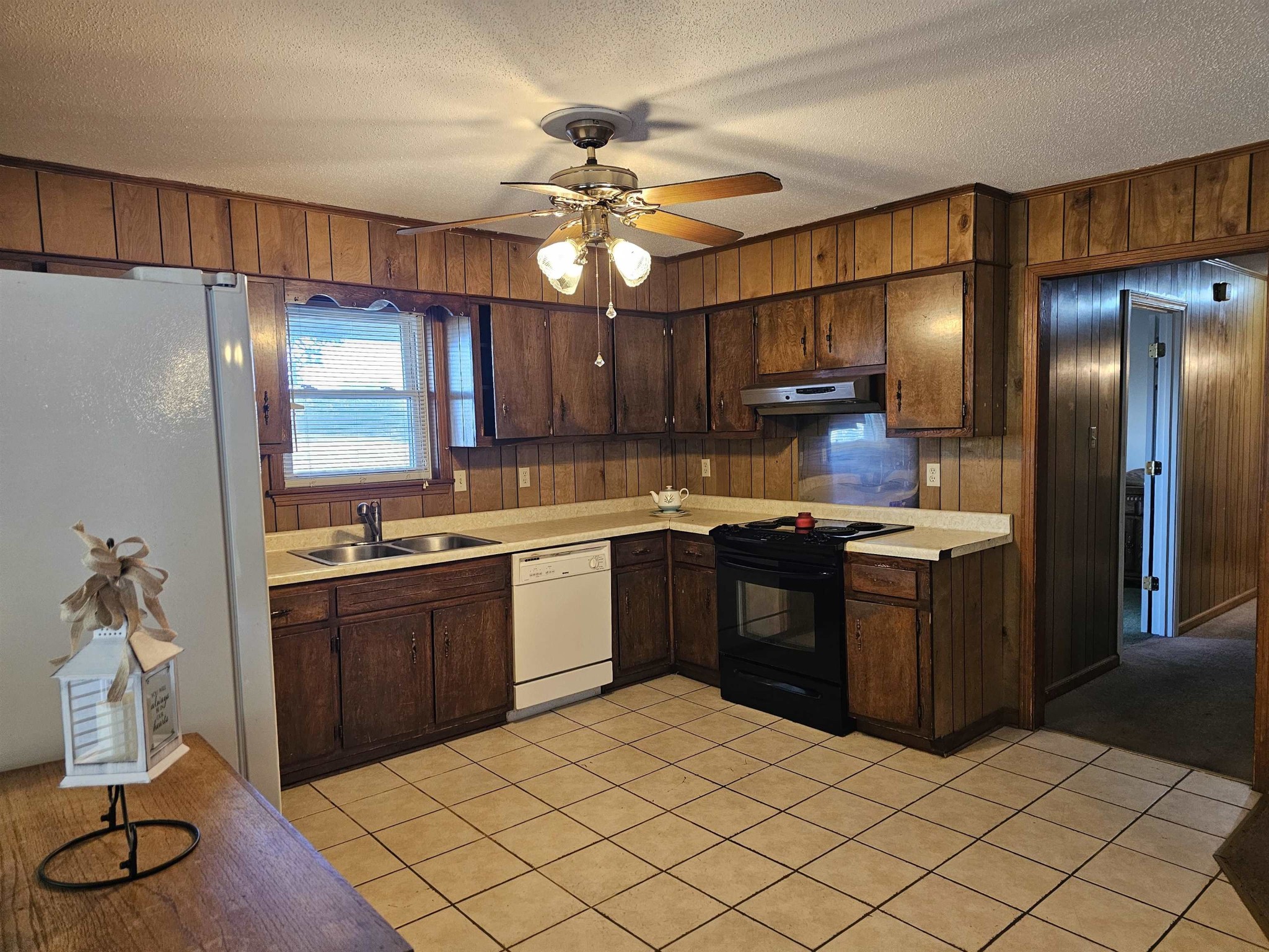 1728 Oil Mill Road Covington, TN 38019 - Photo 5 of 25 a kitchen with a refrigerator and a sink