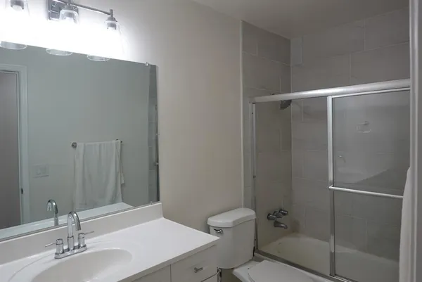 a bathroom with a sink toilet and shower