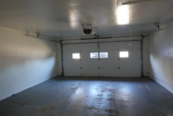 an empty room with a empty space and windows