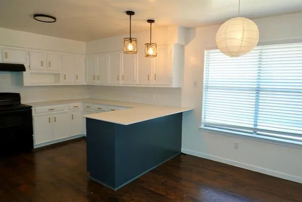 a kitchen with wooden cabinets and sink