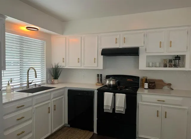 a kitchen with a sink and cabinets