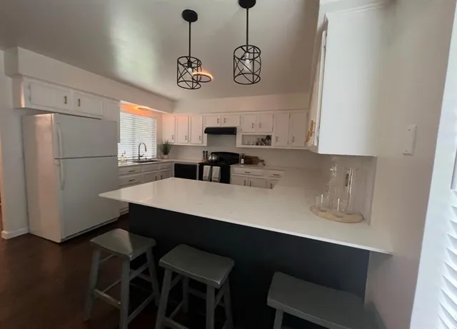 a view of a kitchen with a dining table and chairs