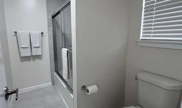 a bathroom with a toilet and a shower