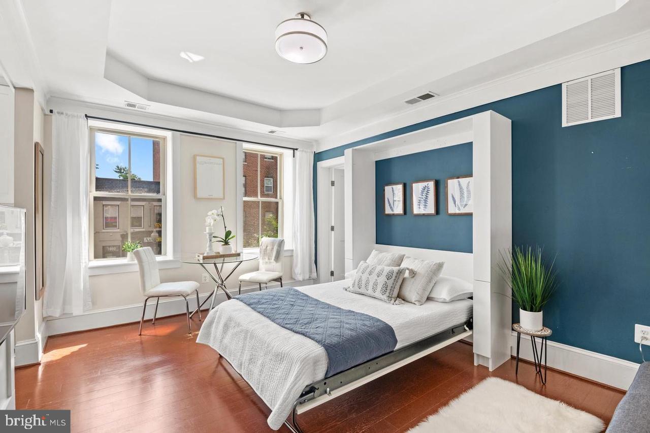 1451 Park Road Northwest, Unit 220 Washington, DC 20010 - Photo 11 of 30 a spacious bedroom with a large bed and a window