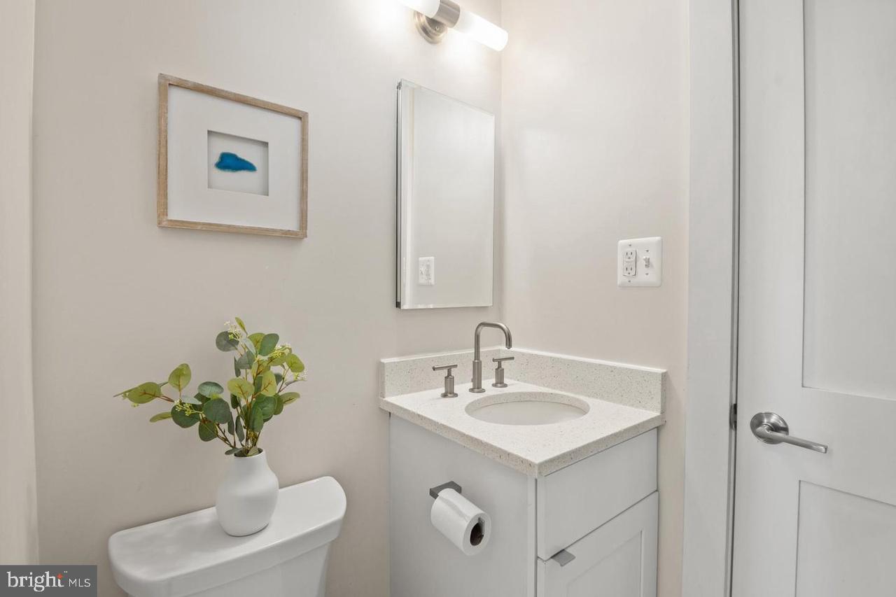 1451 Park Road Northwest, Unit 220 Washington, DC 20010 - Photo 18 of 30 a bathroom with a sink toilet and a mirror