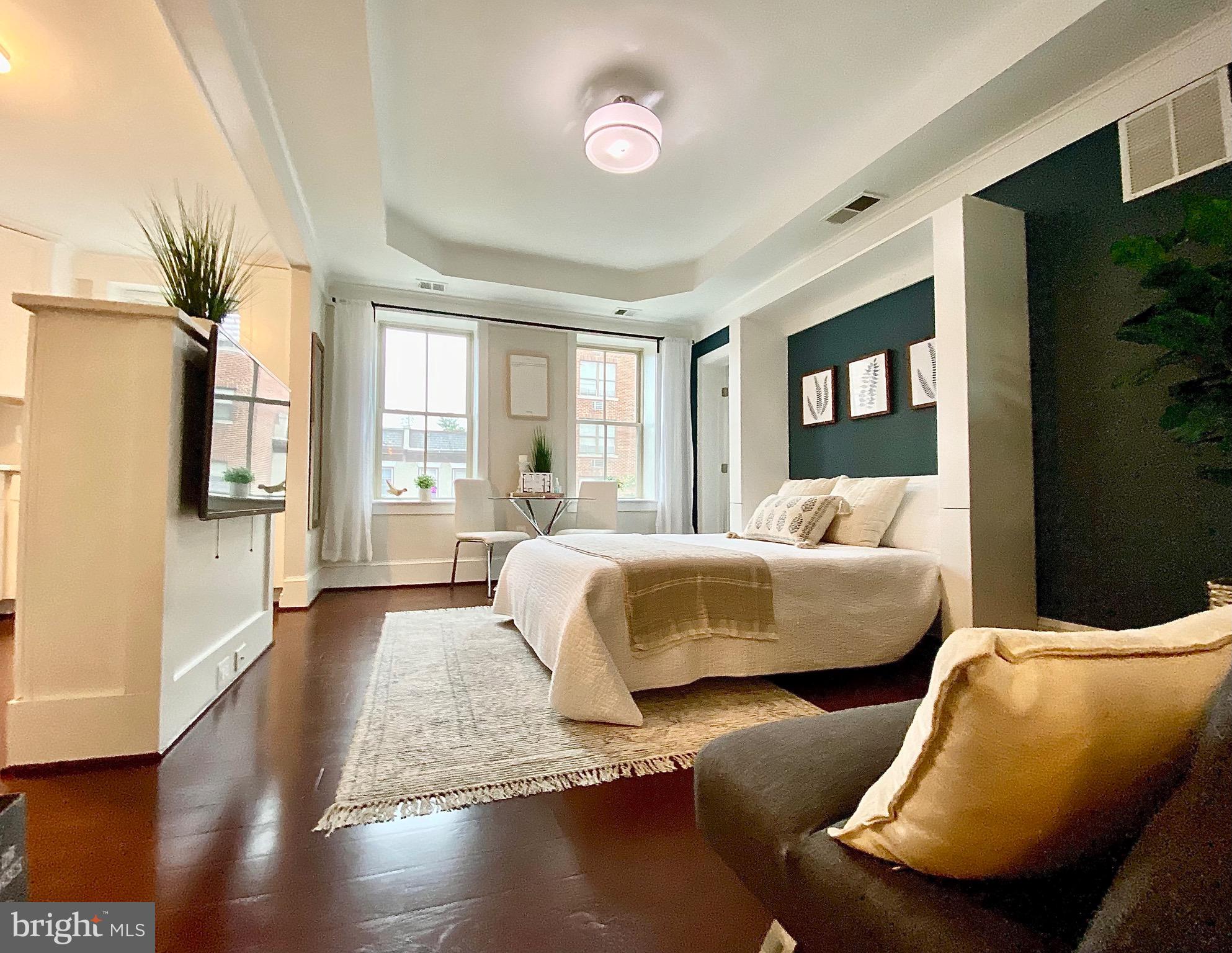 1451 Park Road Northwest, Unit 220 Washington, DC 20010 - Photo 21 of 30 a bedroom with furniture and a flat screen tv