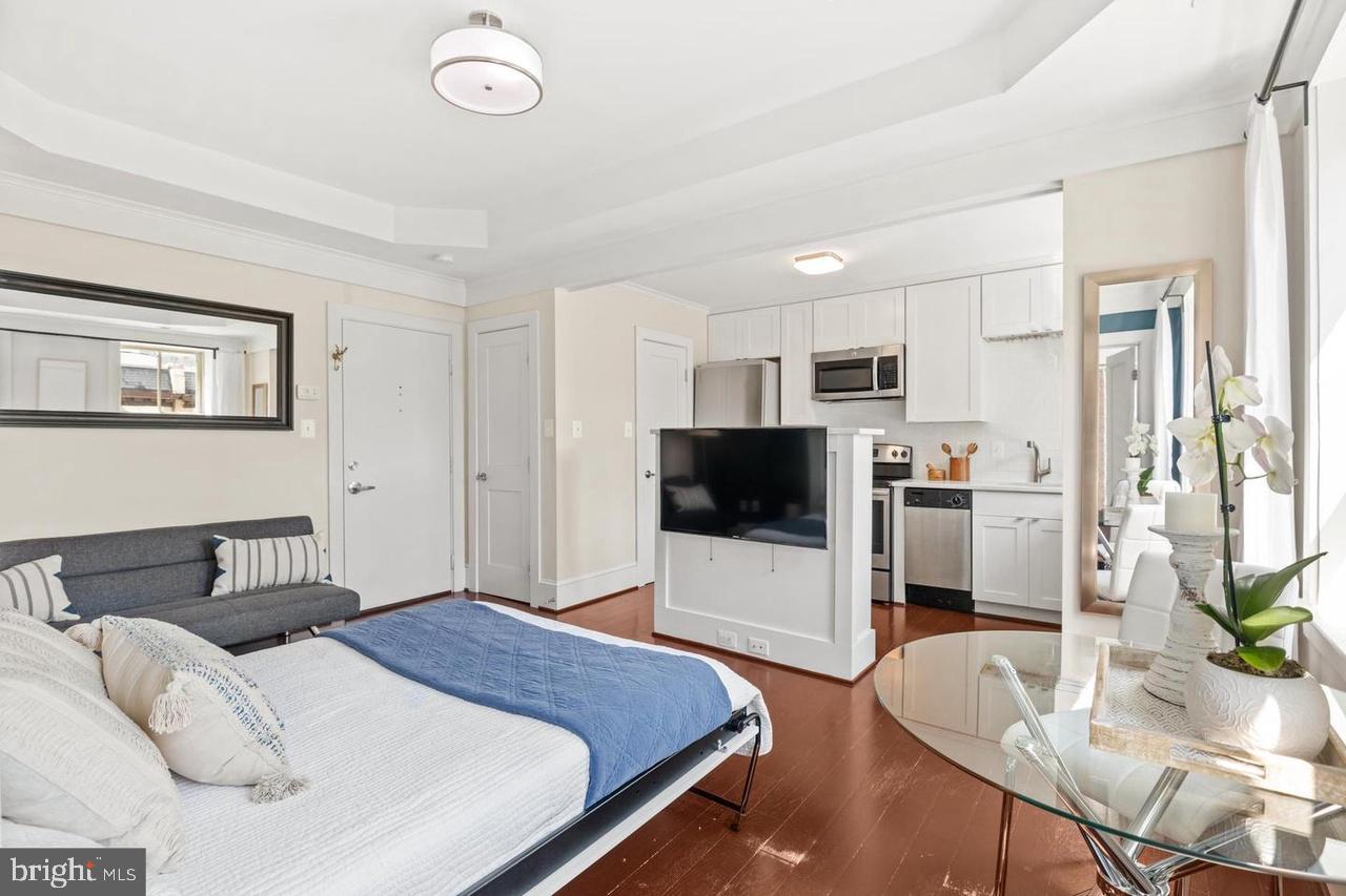 1451 Park Road Northwest, Unit 220 Washington, DC 20010 - Photo 3 of 30 a bedroom with a bed and a flat screen tv