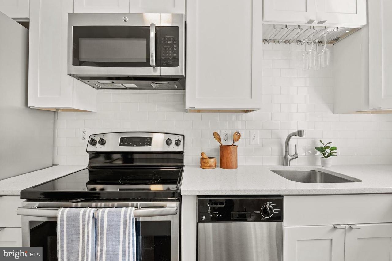 1451 Park Road Northwest, Unit 220 Washington, DC 20010 - Photo 5 of 30 a kitchen with a stove and a microwave