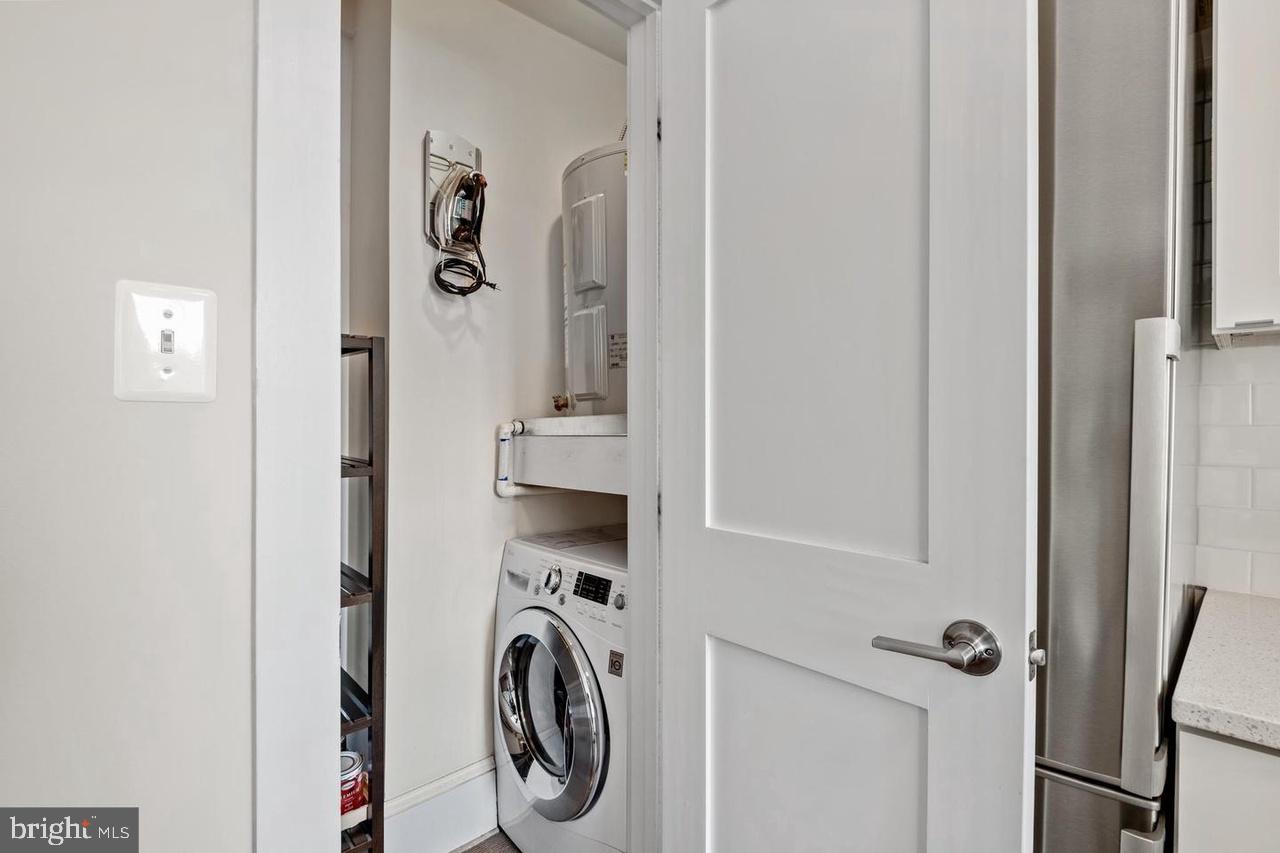 1451 Park Road Northwest, Unit 220 Washington, DC 20010 - Photo 6 of 30 a view of a hallway with washer and dryer