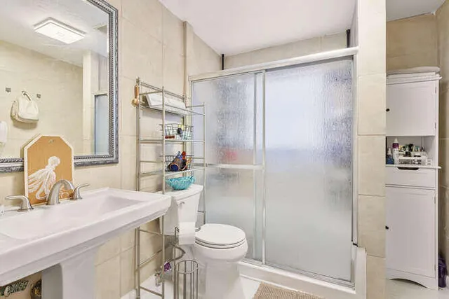 a bathroom with a sink toilet and shower