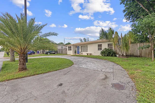 a front view of house with yard and green space