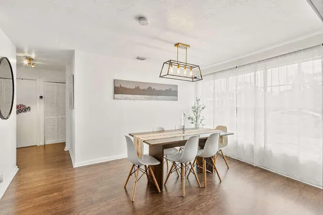 a view of a dining room with furniture window and wooden floor