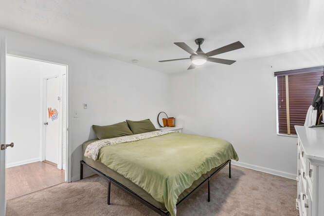 2630 Northeast 10th Avenue Pompano Beach, FL 33064 - Photo 7 of 12 a bedroom with a bed and a ceiling fan