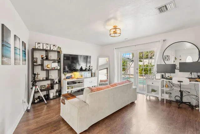 a living room with furniture and a flat screen tv