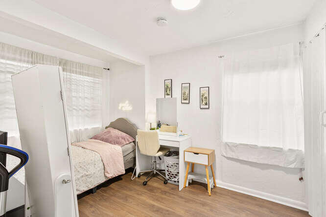 2630 Northeast 10th Avenue Pompano Beach, FL 33064 - Photo 9 of 12 a bed room with a bed and a chair