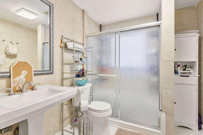 2630 Northeast 10th Avenue Pompano Beach, FL 33064 - Photo 10 of 12 a bathroom with a sink toilet and shower