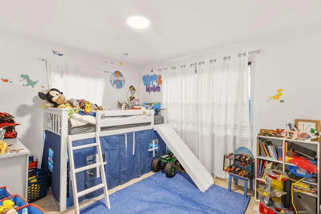 a bedroom with furniture and a book shelf