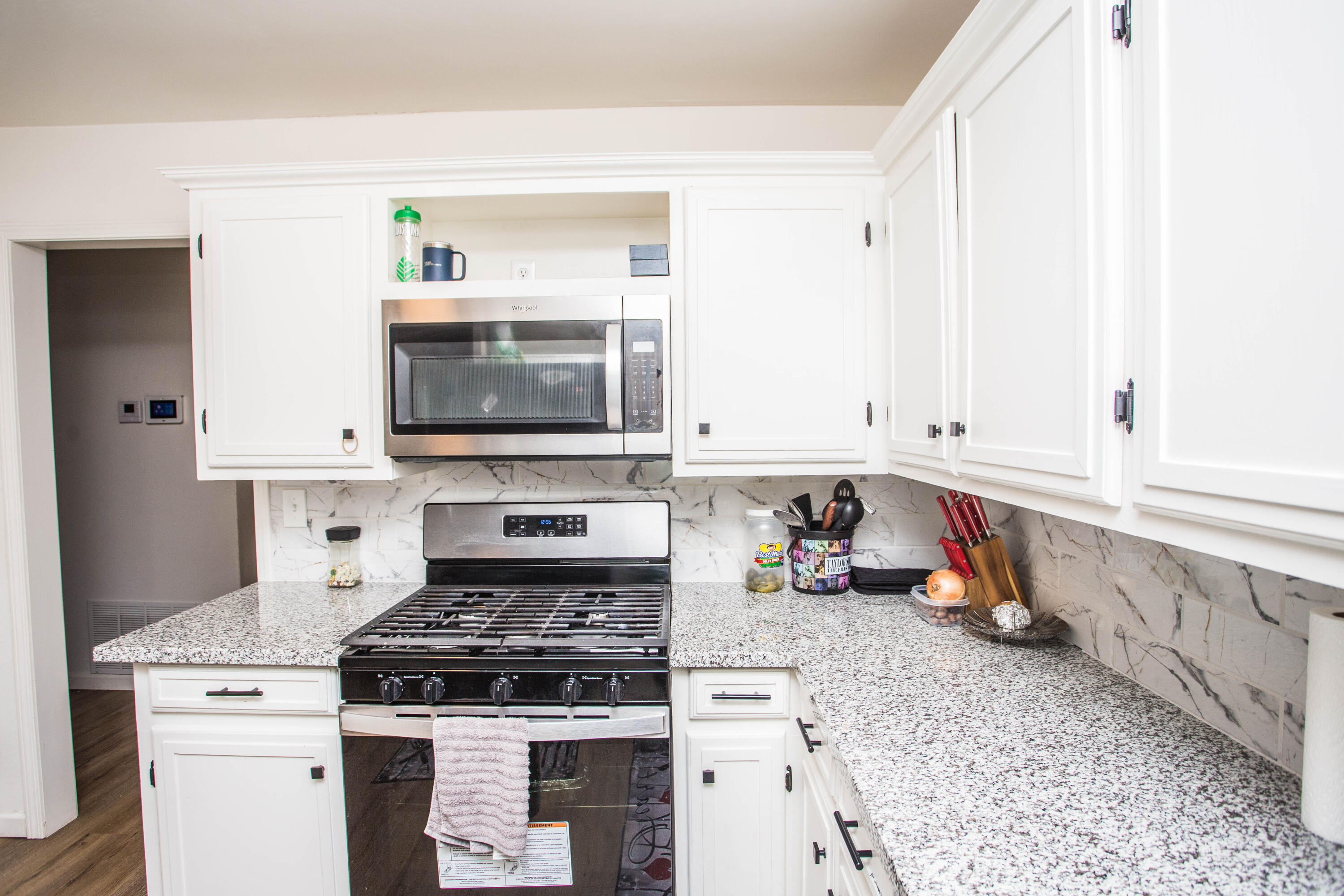 2604 39th Street Lubbock, TX 79413 - Photo 15 of 43 a kitchen with stainless steel appliances granite countertop a stove and a microwave