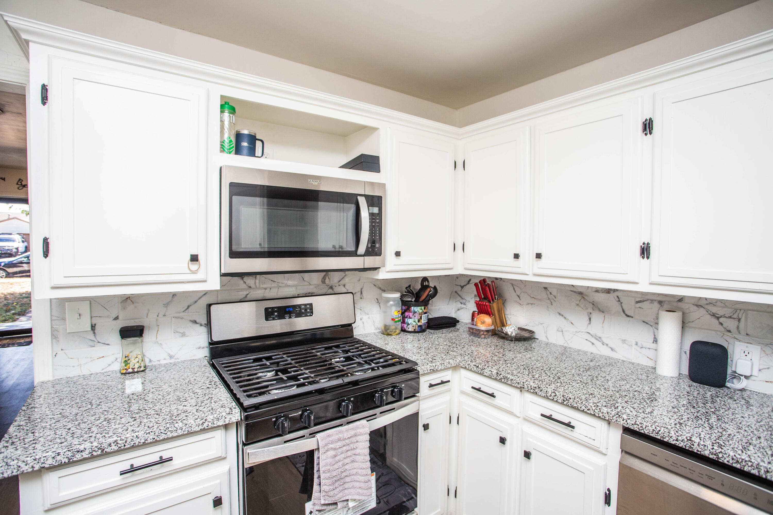 2604 39th Street Lubbock, TX 79413 - Photo 16 of 43 a kitchen with stainless steel appliances granite countertop a sink stove and microwave