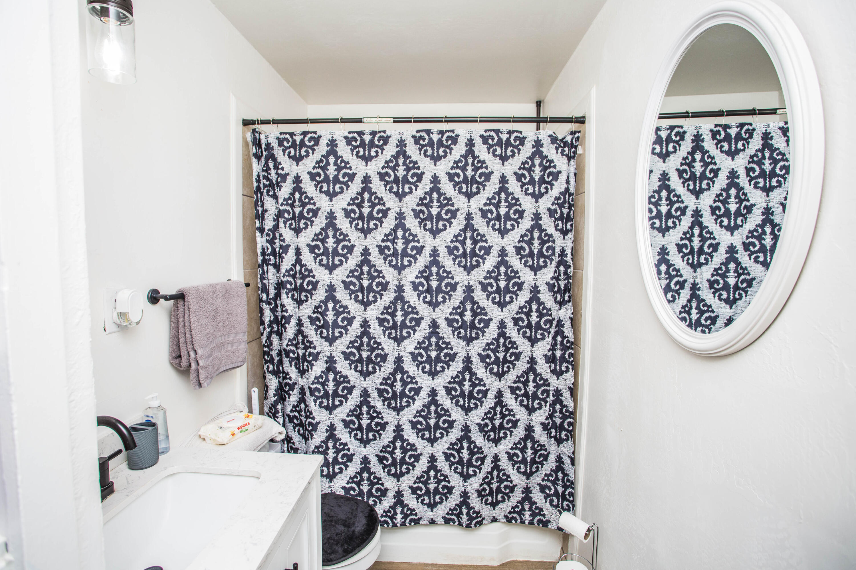 2604 39th Street Lubbock, TX 79413 - Photo 17 of 43 a bathroom with a shower curtain and a sink