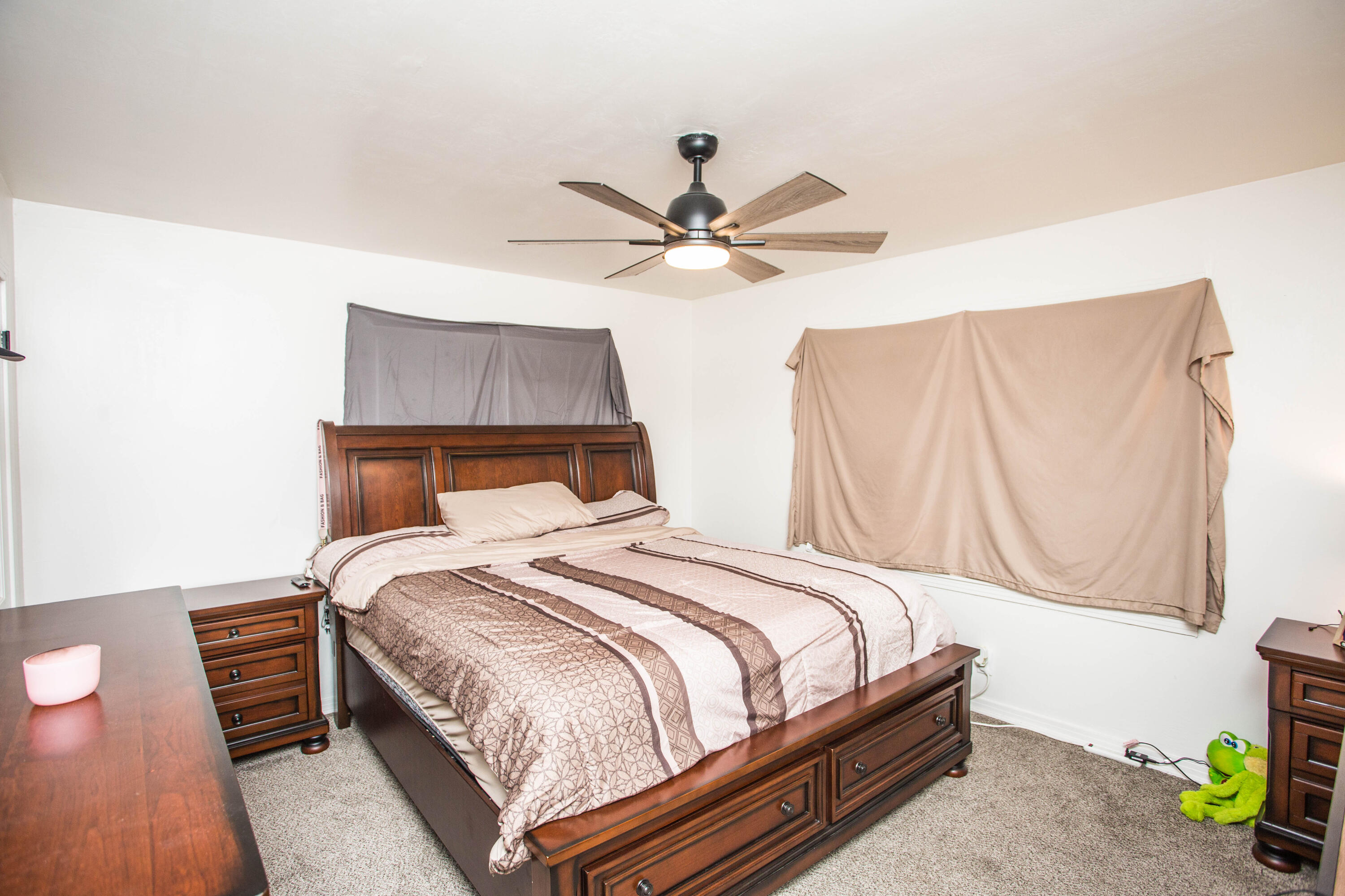 2604 39th Street Lubbock, TX 79413 - Photo 26 of 43 a bedroom with a bed and a chandelier