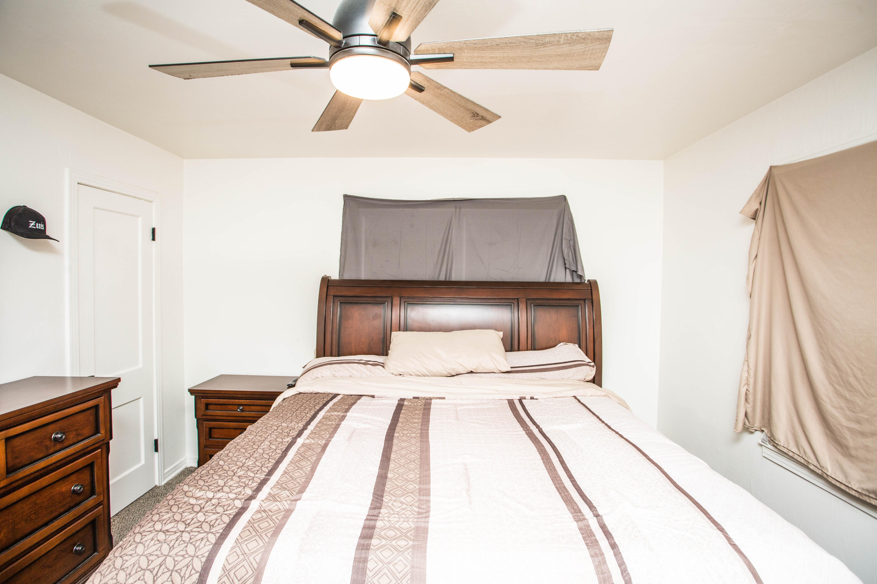 2604 39th Street Lubbock, TX 79413 - Photo 27 of 43 a bedroom with a bed and a chandelier