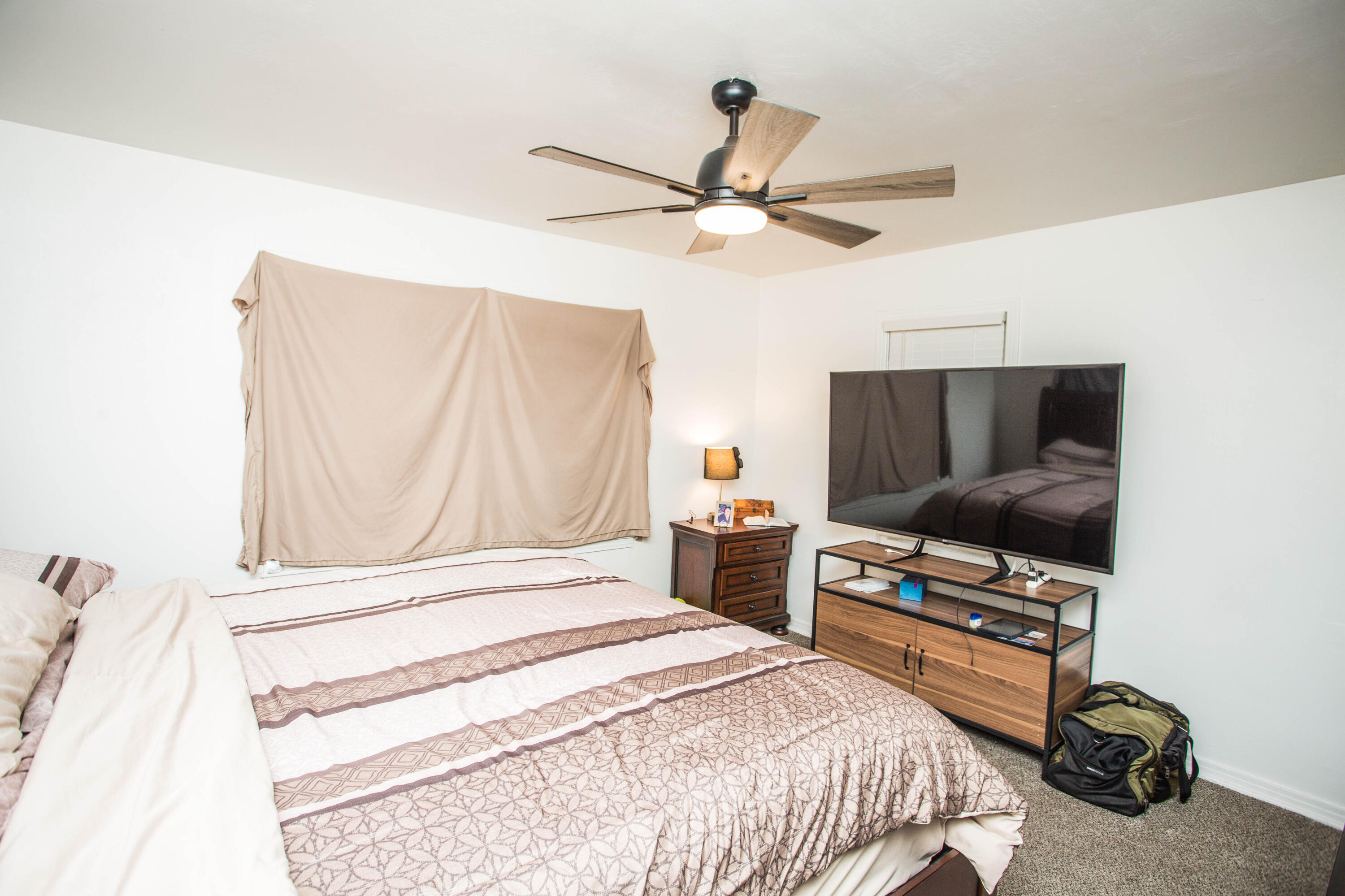 2604 39th Street Lubbock, TX 79413 - Photo 29 of 43 a bedroom with a bed and a flat screen tv