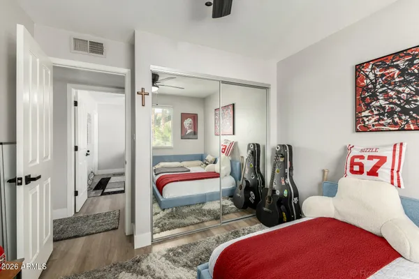 a view of a bedroom with two bed and a view of bathroom