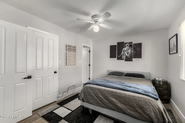 a bedroom with a large bed and a chandelier